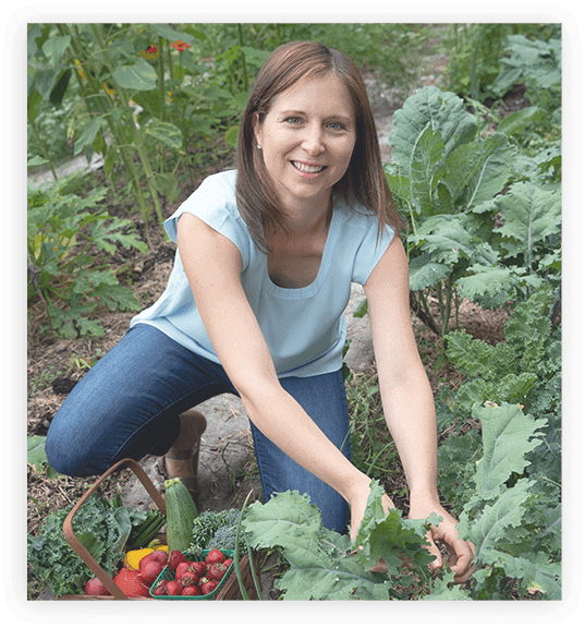 Sarah, The Functional Foodie, picking veggies in veggie garden